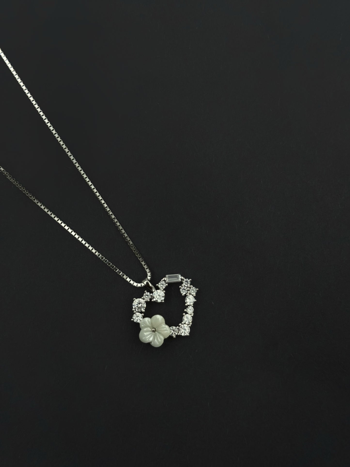 Heart pendant with flower.
